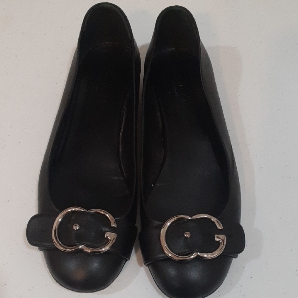 Gucci Black Leather Flats with Silver Buckle.